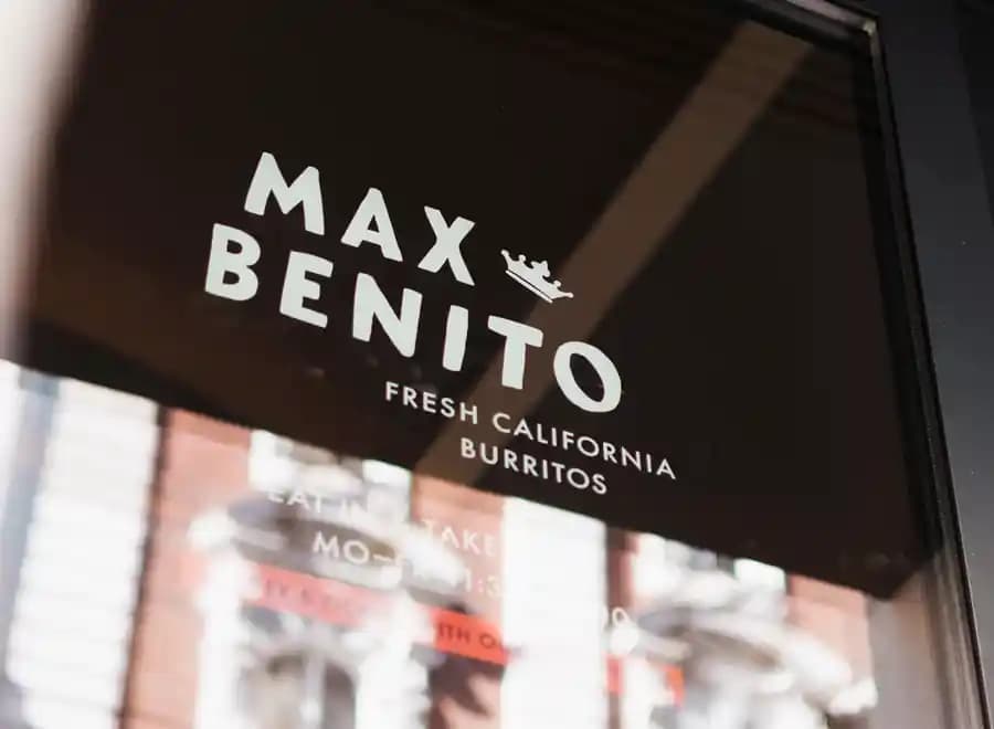 Max & Benito store front with logo on the glass door
